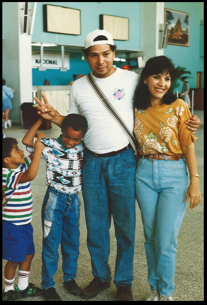 little Hey-Seuss pulling on Fabien,
              hanging on Robbie, arm around Brenda