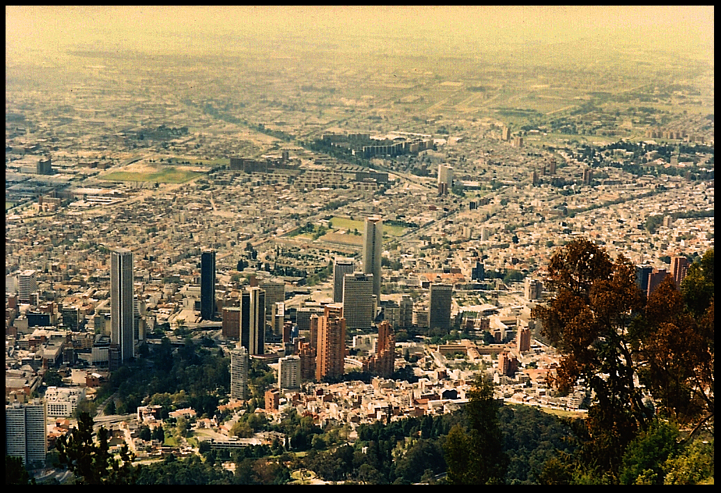 skyscrapers and dense smog of
              vallley city seen from high on neighbor mountain