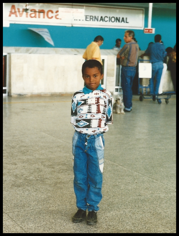 10 year old Fabién all neat
              with tight curls and aqua pants and shirt