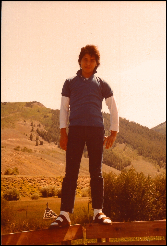 neatly dressed young Colombian male in sandals and
            white socks