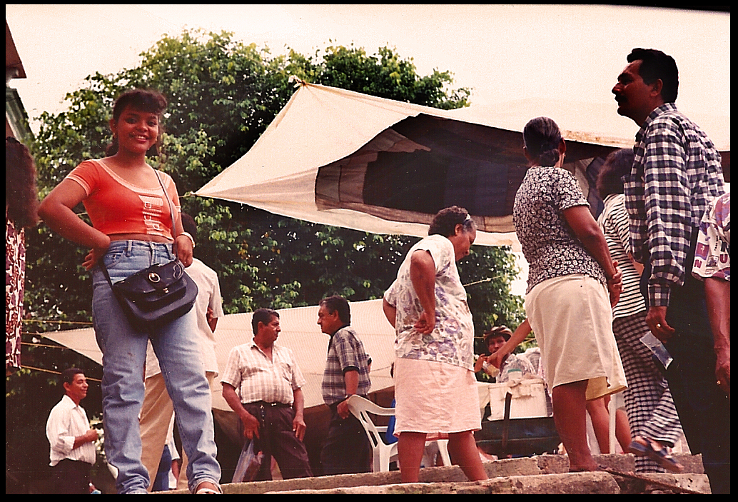 Sandi atop the main dock
              steps with town plaza behind her busy on market day