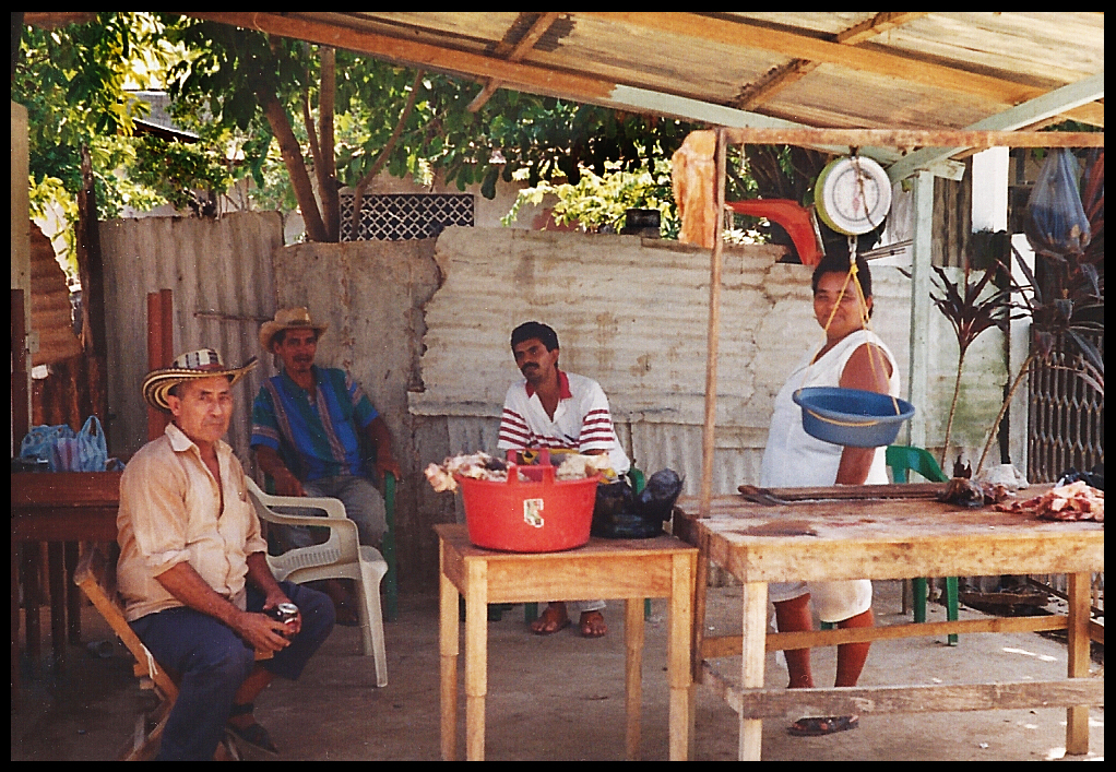 Victoria entertaining three
              male friends in a rustic Santisima Cruz butcher shop