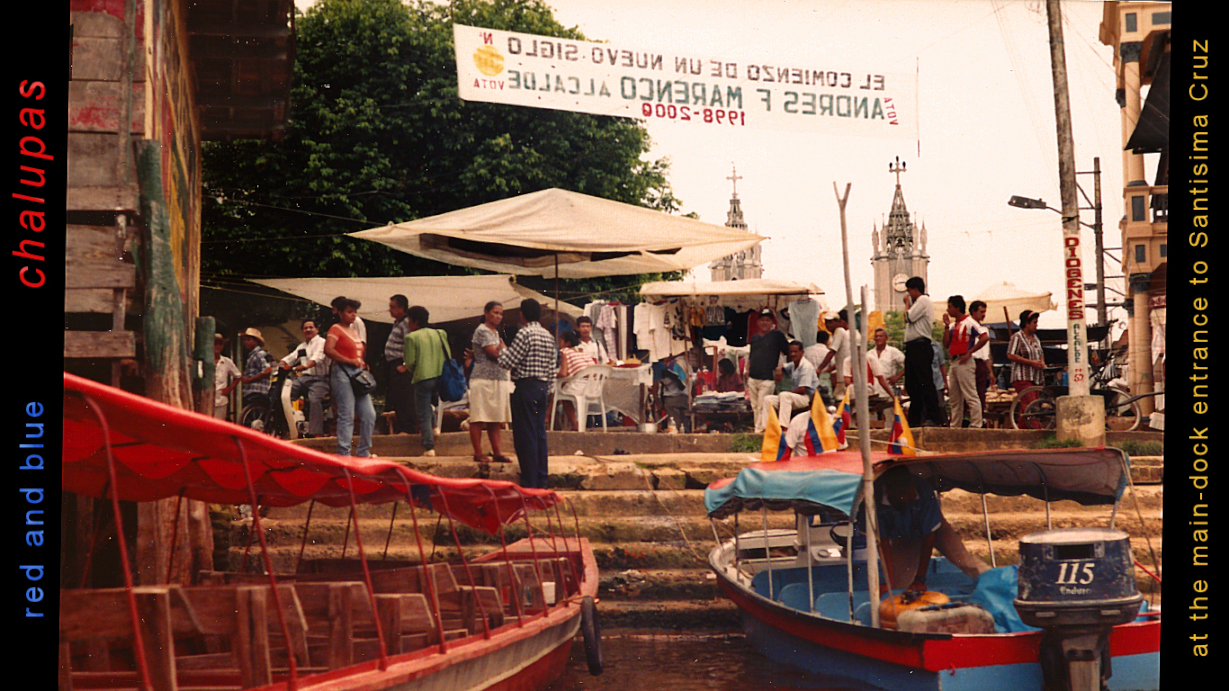 red and blue
              chalupas at the main dock and plaza, Santisima Cruz