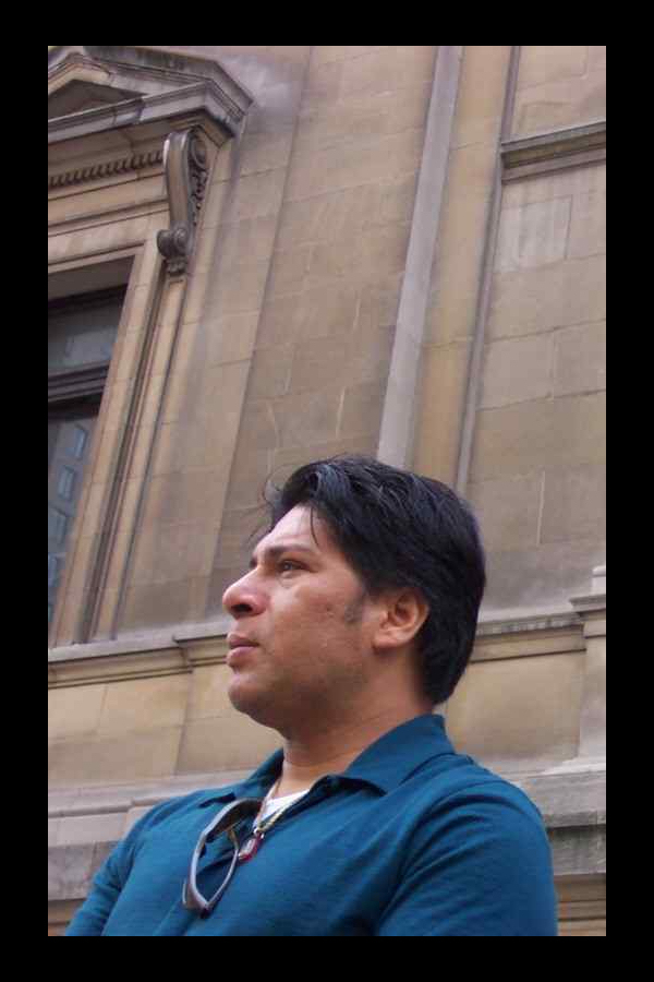 Robbie Rivera standing quite
            proudly before the NYC Federal Building the day in 2004 he
            became a citizen