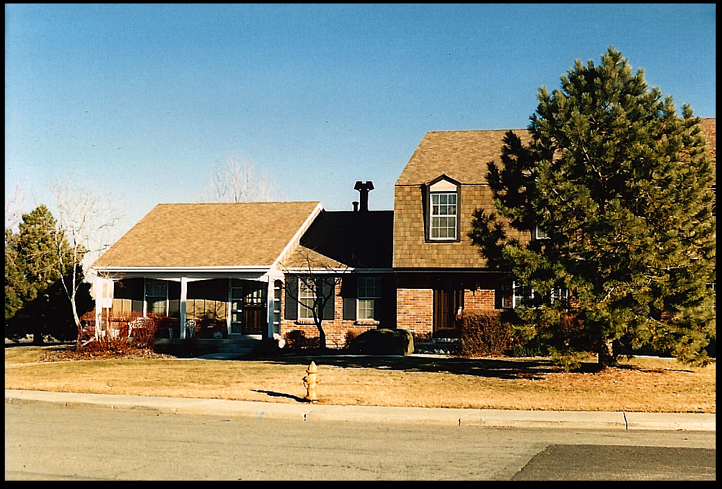 handsome brick colonial-style
              rowhouse in Denver suburbs with aspen and ponderosa pine