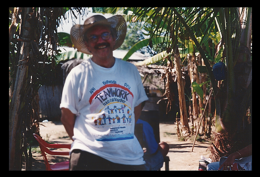 Dr. Lorenzo grinning in native coastal Colombian
              straw hat wearing a new white T-shirt from Denver psych
              hospitals that colorfully lauds 'Teamwork'