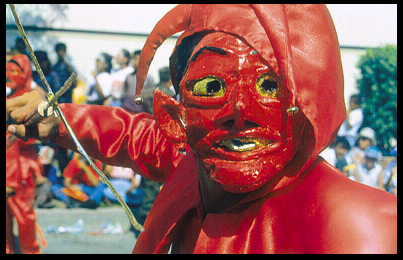 face of red devil wielding cross as
              weapon