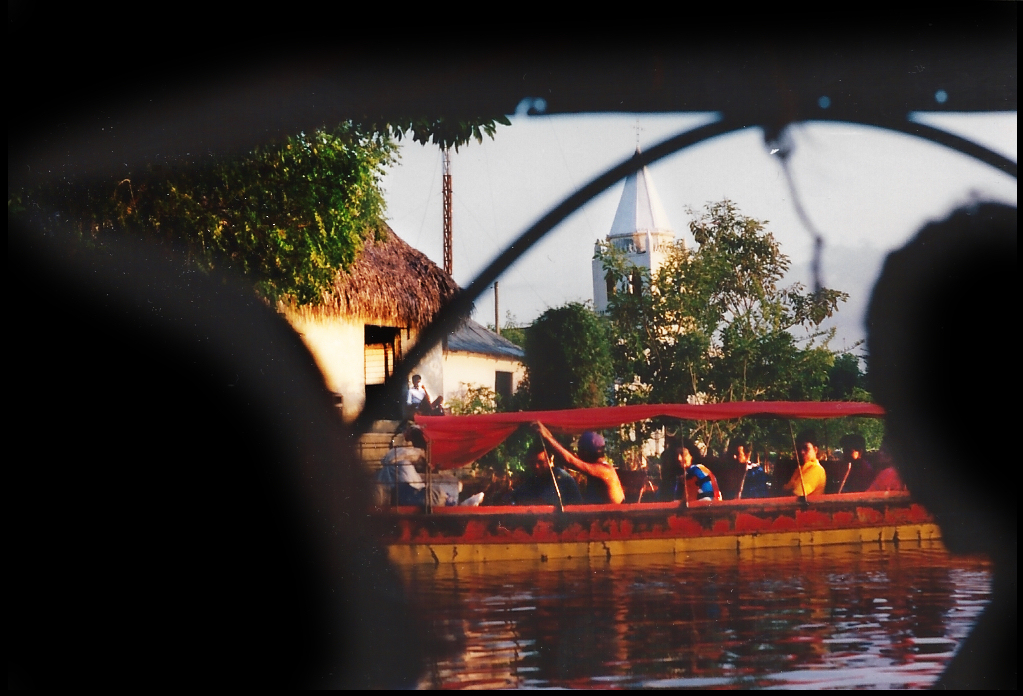 decked downriver passenger
              motor launch passes town with church