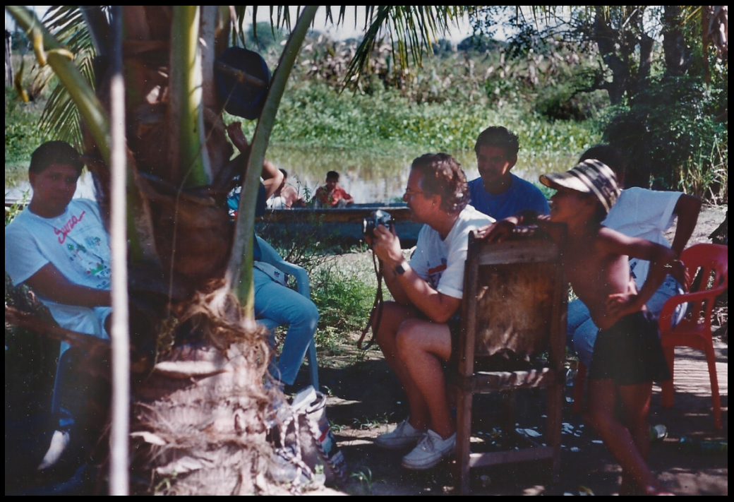 the Dr. in shorts with
              camera, surrounded by Colombian river country friends