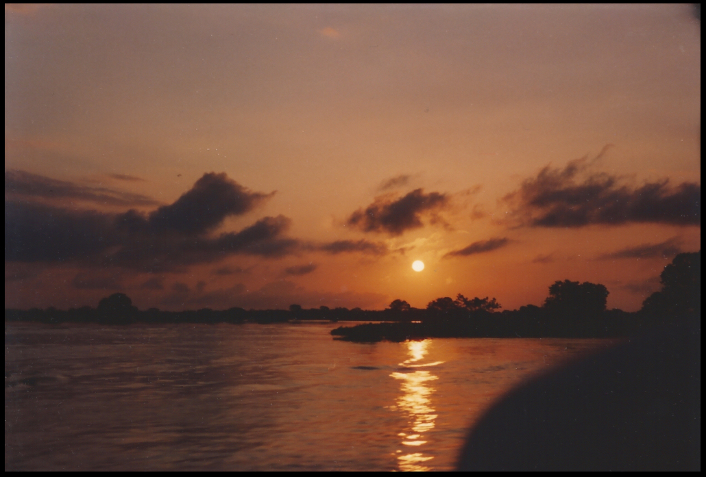 deep oranges and purples, foreground
            all river, low rising sun reflected in it as a pathway to
            the viewer