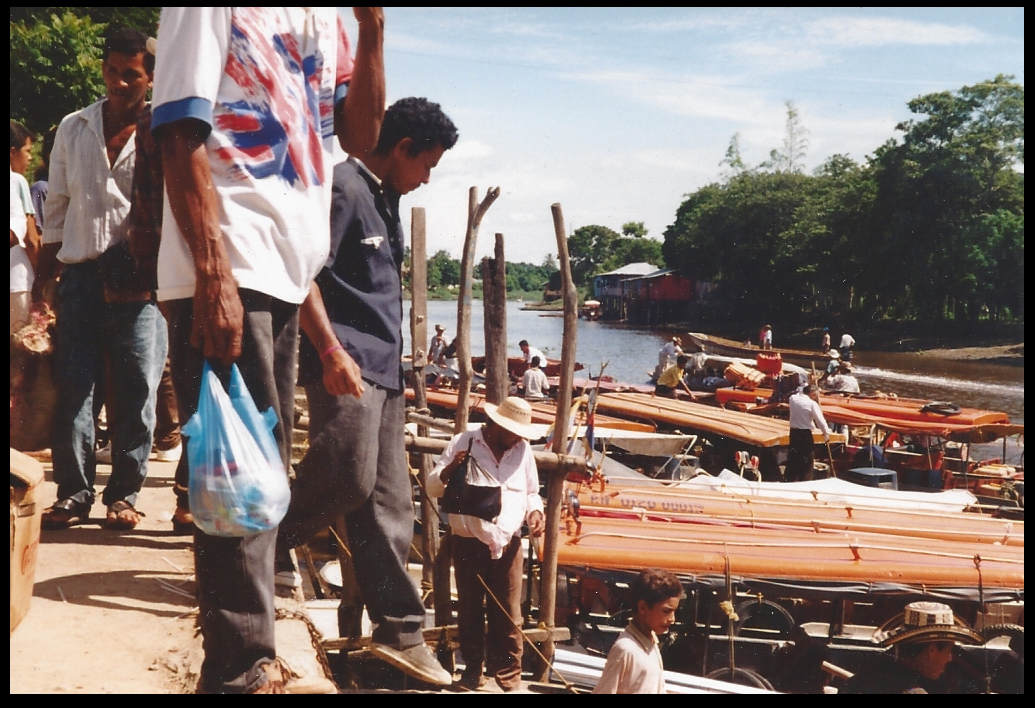 multiple river launches load
              and unload people and goods at Santisima Cruz' secondary
              town docks