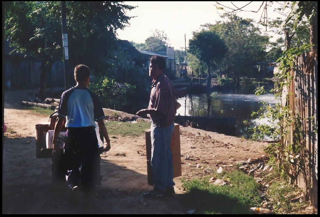 luggage on a wooden
              wheelbarrow pushed from docks to house