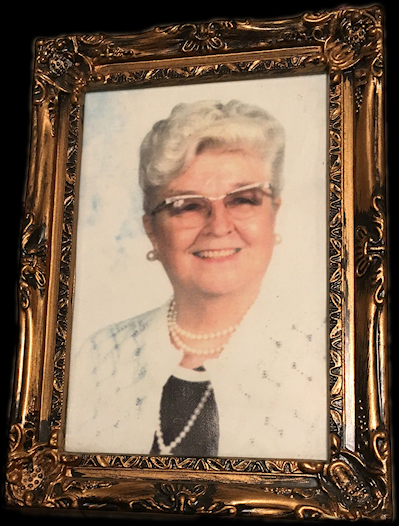 perfectly respectable hairdo,
              glasses frames, earrings, pearl necklace and smile on
              55-ish white-haired matron of morality and political
              uprightness