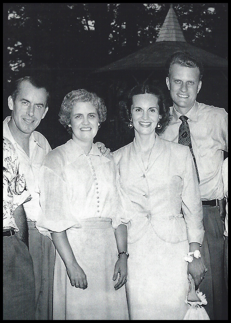 black and white photo: two well-dressed and handsome
            smiling couples in a semi-formal pose