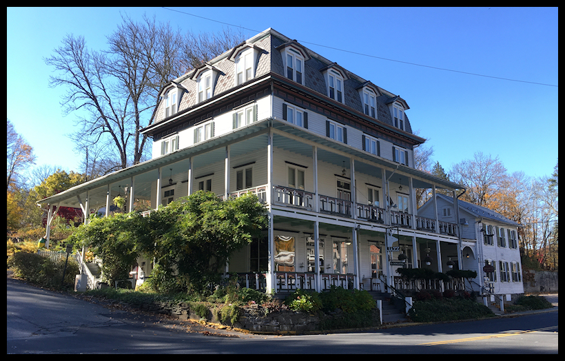 elegant white
              turn-of-the-century four-storey Poconos inn with big
              windows, railinged porches and a cute colonial-style
              sidehouse