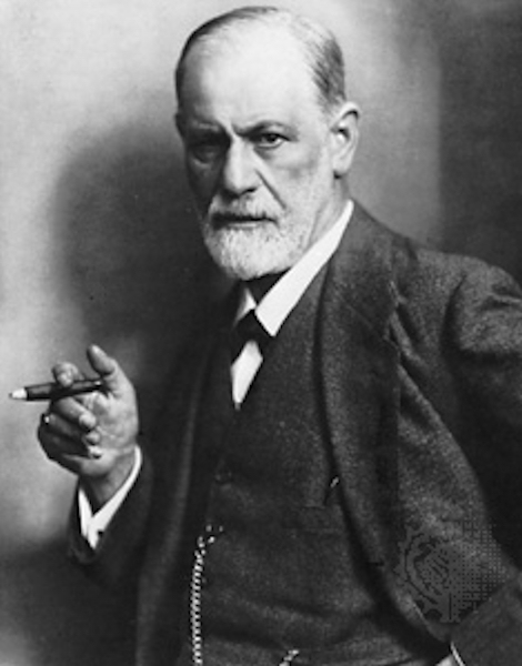 Freud: professional
              photo portrait in black and white, cigar in hand, neatly
              trimmed white beard, watch fob chain hung correctly, stern
              gaze into camera