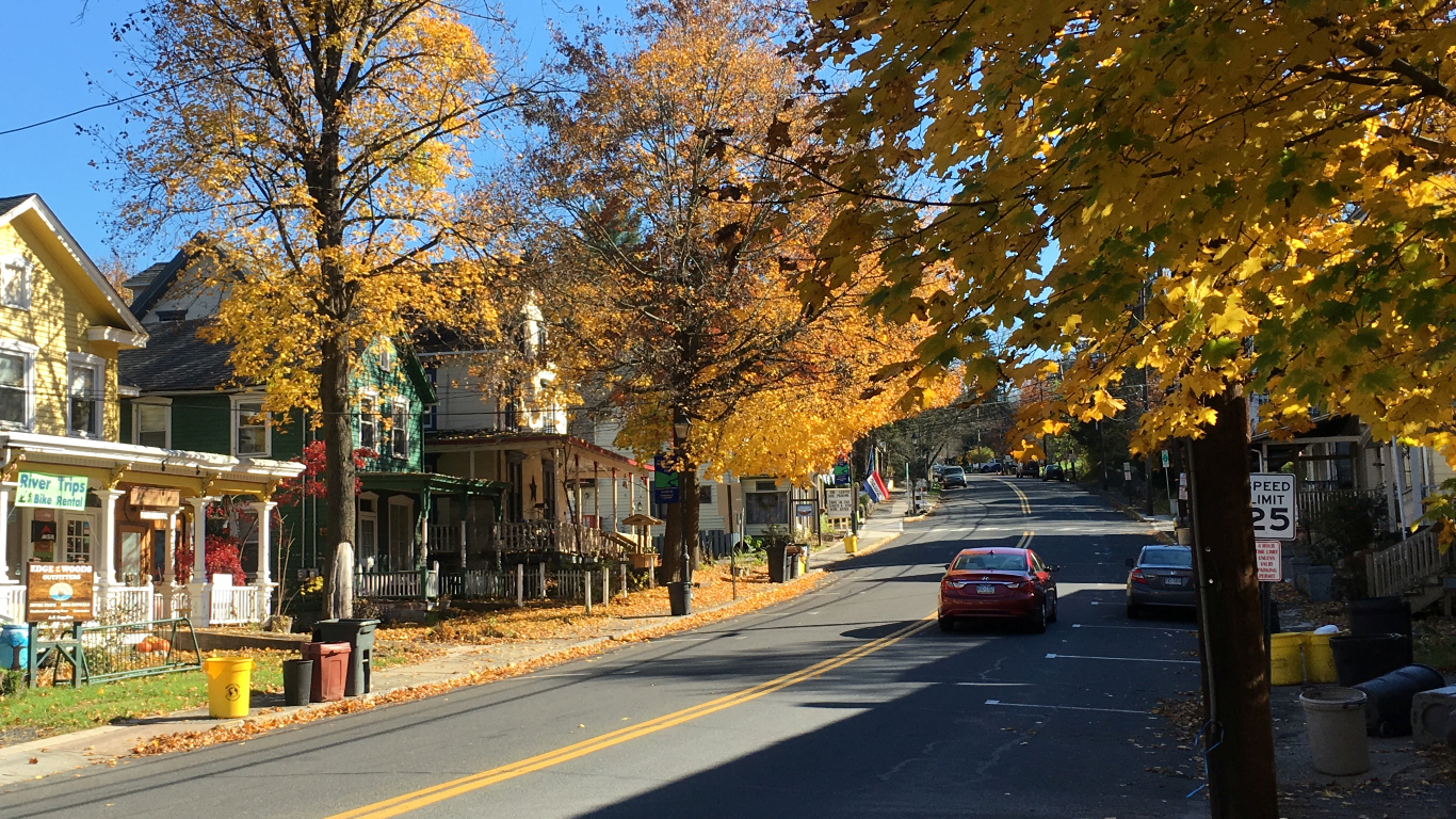 two-way street lined both sides with
              lovely big old houses, all painted yellow by leaves in
              trees and on ground