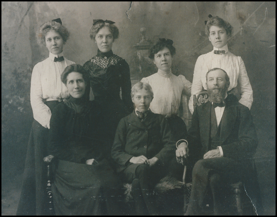 old black and
            white photo: lovely late-Victorian blouses and bows on four
            20-ish sisters standing behind parents and their coddled and
            wide-eyed 14-year-old brother, the Dr.'s (great) 'Uncle
            John', family jokesmith and storyteller